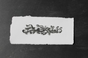Monoprint of Sweet Pea growth - Ink on paper unmounted. Presented here on slate - Approx 80 mm x 30 mm.